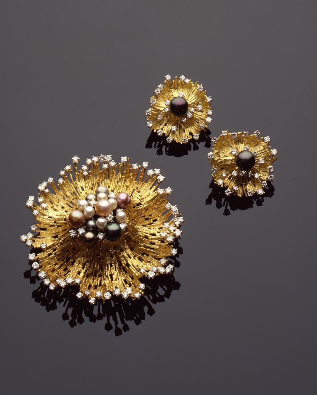 Earrings and Brooch Set in gold textured wire, natural pearls and diamonds by Andrew Grima. Image Courtesy of F. Grima